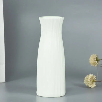A sleek white ceramic modern flower vase with vertical ridges and flared rim for home décor by decorbites