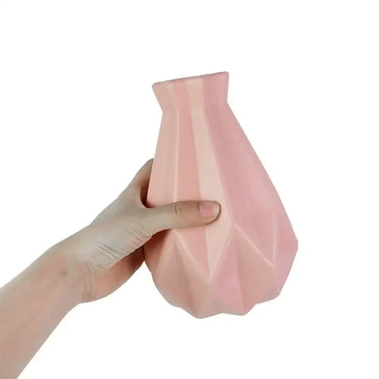 A soft pink modern flower vase with geometric facets made of colorful plastic for home décor by decorbites