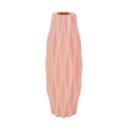 A tall blush pink modern flower vase with a ribbed ceramic surface and copper-toned interior for home décor