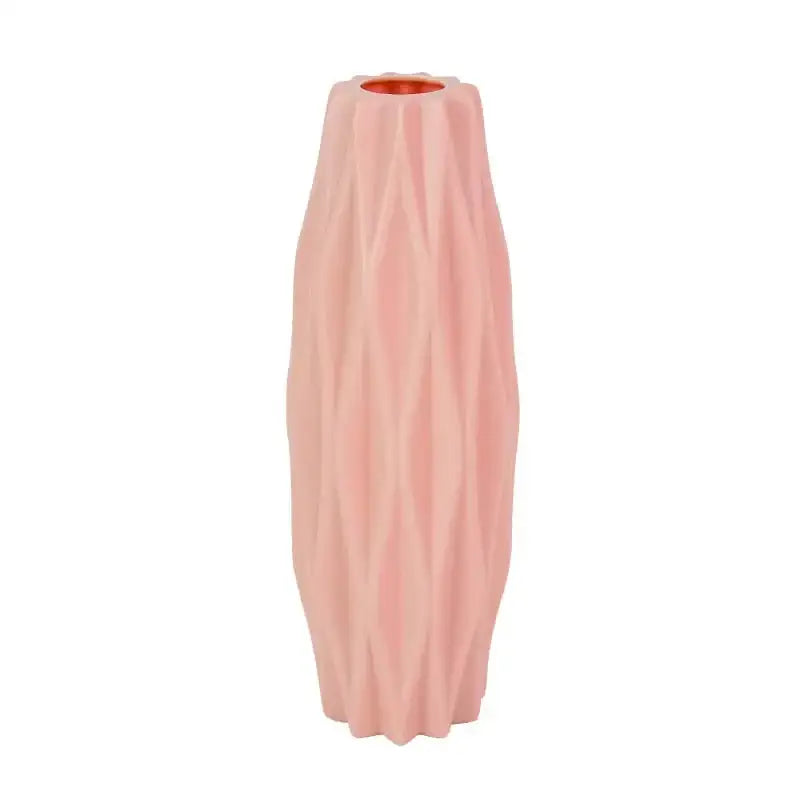 A tall blush pink modern flower vase with a ribbed ceramic surface and copper-toned interior for home décor