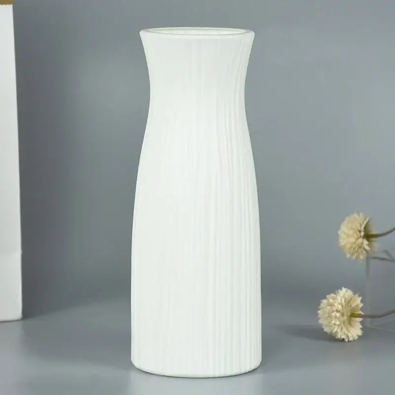 A tall slender white ceramic modern flower vase with vertical ribbed texture for home décor by DecorBites™