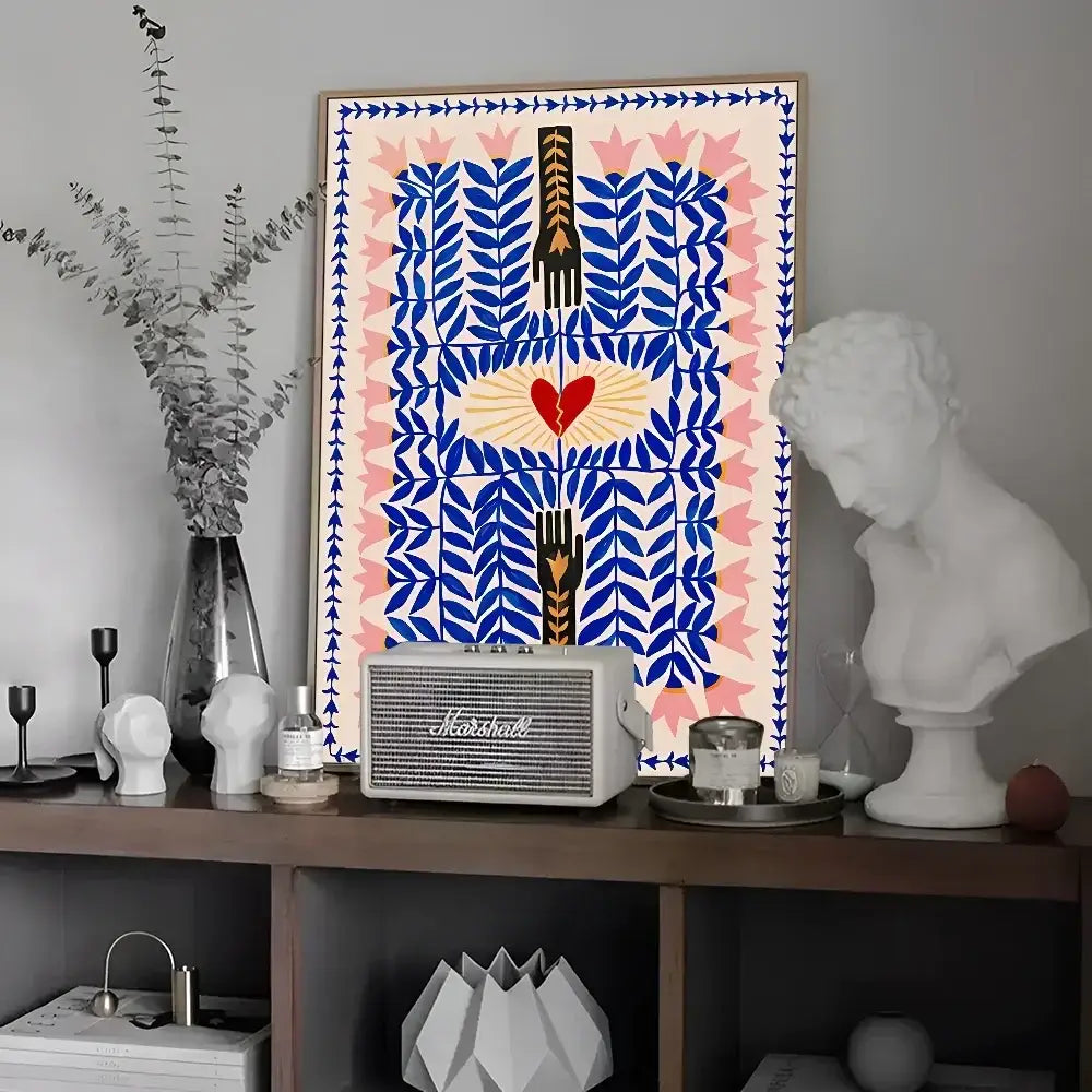 A framed decorbites™ wall art featuring blue and pink leaves, a red heart with golden rays, and black hands vintage poster