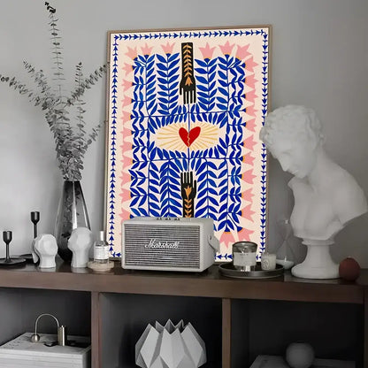 A framed decorbites™ wall art featuring blue and pink leaves, a red heart with golden rays, and black hands vintage poster