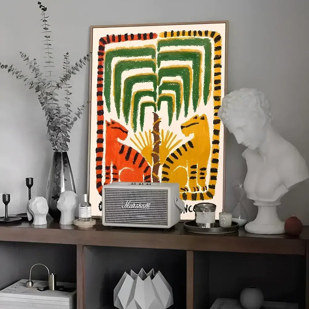 A vintage-style white Marshall speaker with silver accents on a shelf complements colorful tiger and leopard vintage poster wall art