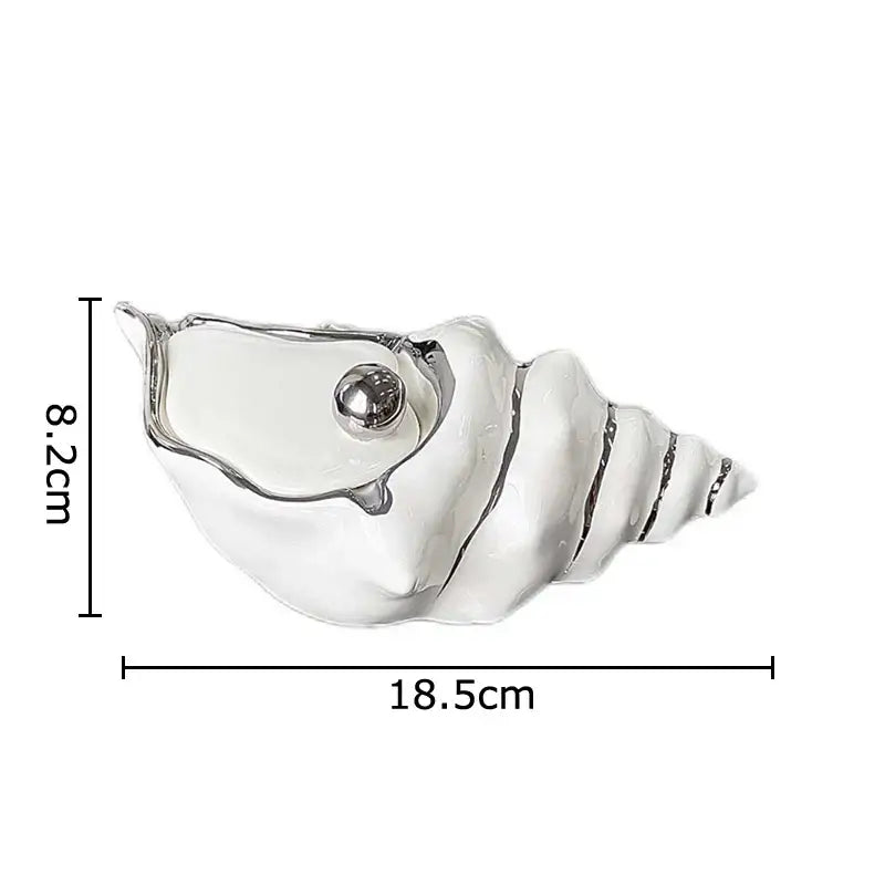A sleek white ceramic decorbites conch ashtray with a polished silver metallic sphere for living room decor