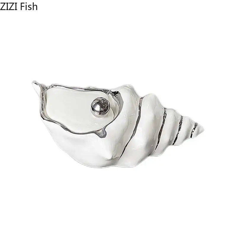 A sleek white ceramic decorbites conch ashtray with silver metallic eye and ridged detailing for living room decor