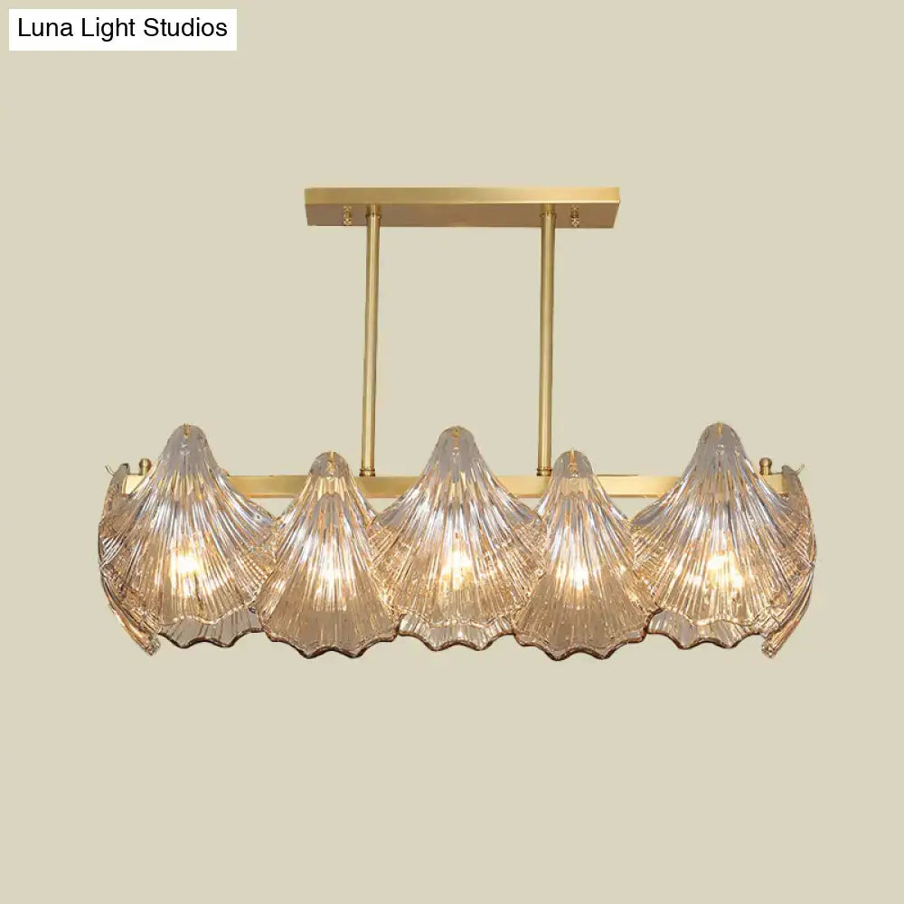 Gold-toned decorbites™ amber crystal pendant light with five ribbed glass shades and brass island lighting linear metal arm