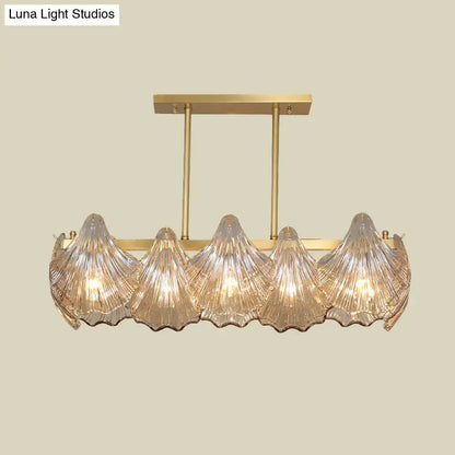 Gold-toned decorbites™ amber crystal pendant light with five ribbed glass shades and brass island lighting linear metal arm