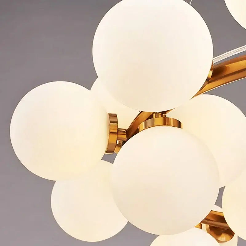 DecorBites™ contemporary black and gold chandelier with frosted white glass ball shades and polished metal arms