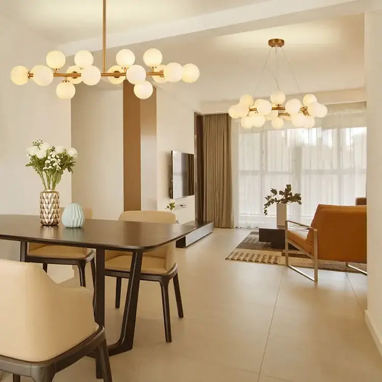 Contemporary DecorBites black and gold chandelier featuring spherical frosted white glass ball globes