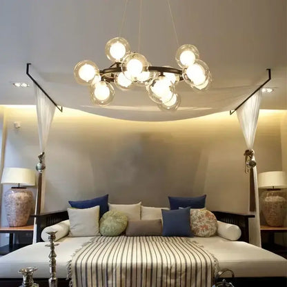 DecorBites contemporary black and gold chandelier with dark metal frame and multiple clear white glass ball bulbs