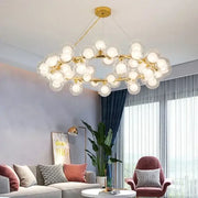 Decorbites™ contemporary black and gold chandelier with white glass ball bulbs in a modern branching design