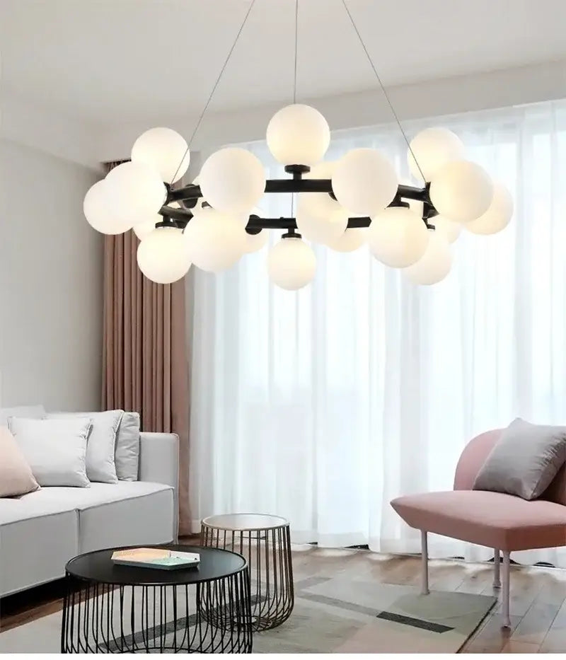 DecorBites contemporary black and gold chandelier featuring numerous frosted white glass ball globes
