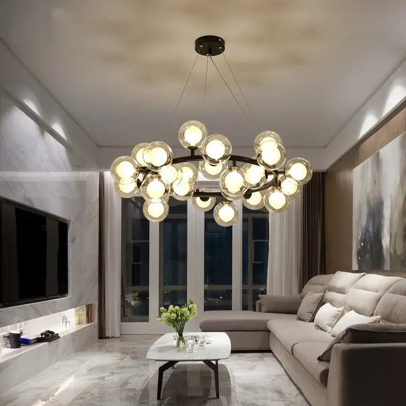 Modern chandelier by DecorBites with multiple white glass balls in a circular arrangement on black and gold frame