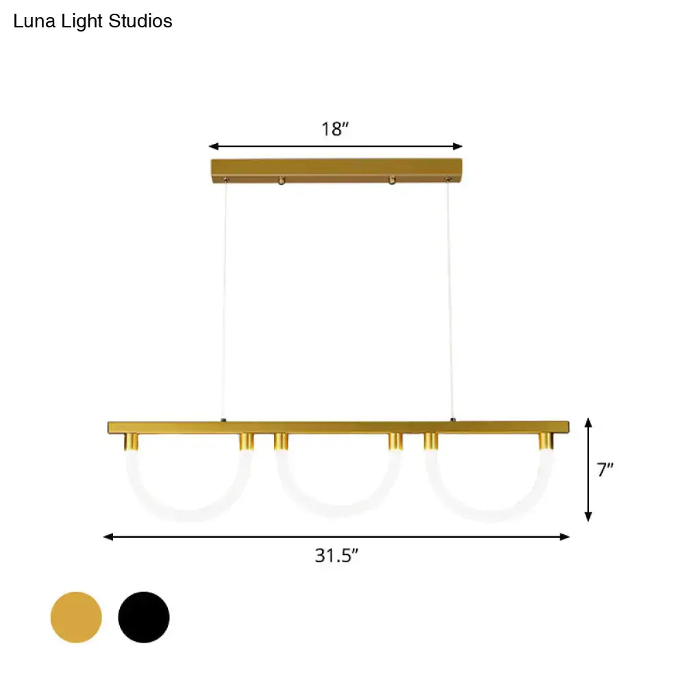Gold-finished contemporary island lamp with three circular acrylic glass shades suspended by thin cords for kitchen island