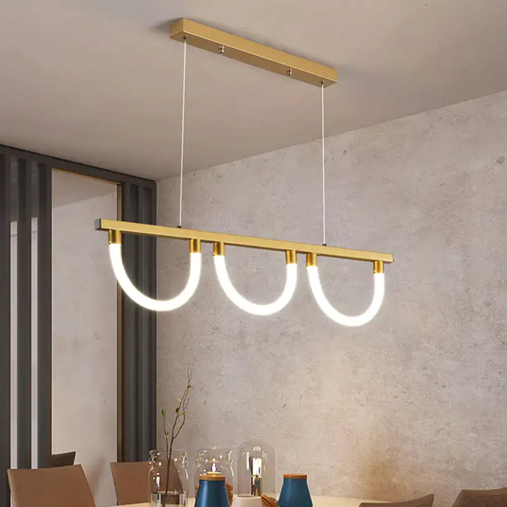 Modern gold-toned rectangular decorbites™ contemporary island lamp with three glowing white led elements suspended by thin cords