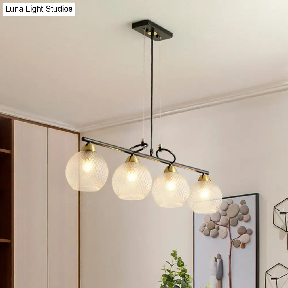 Modern black metal chandelier with four frosted globe shades and brass accents featuring clear prismatic glass for dining hall