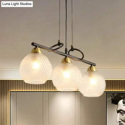 Modern three-light pendant fixture with frosted textured glass globes brass accents for dining hall with prismatic glass