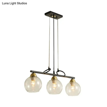 DecorBites™ black metal chandelier with three clear prismatic glass globes and brass accents for dining hall lighting
