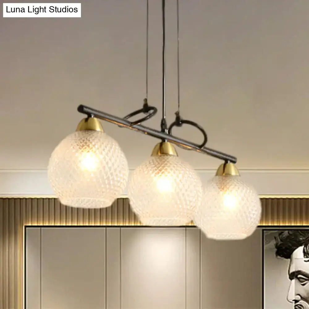 Decorbites contemporary black three-light pendant fixture with frosted globes and brass accents for dining hall with prismatic glass