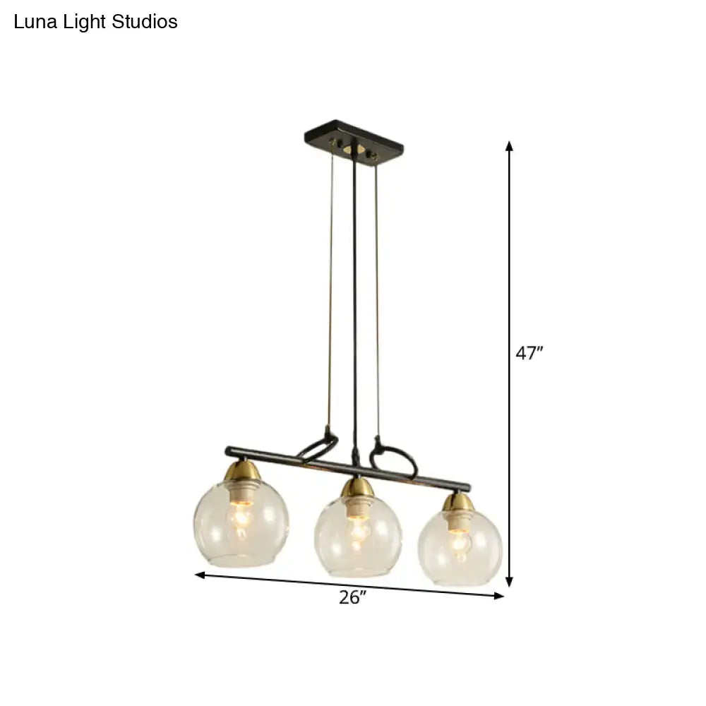 DecorBites™ contemporary black metal pendant light with three clear prismatic glass globes and brass accents for dining hall