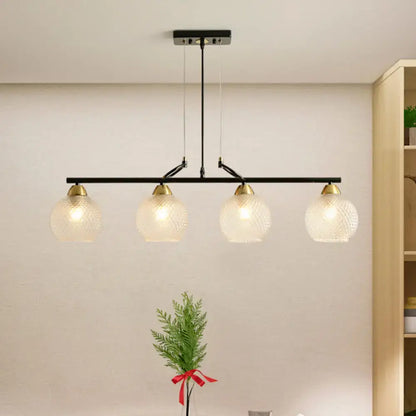 Decorbites™ contemporary black metal bar pendant light with four frosted globe shades and brass accents for dining hall with clear prismatic glass