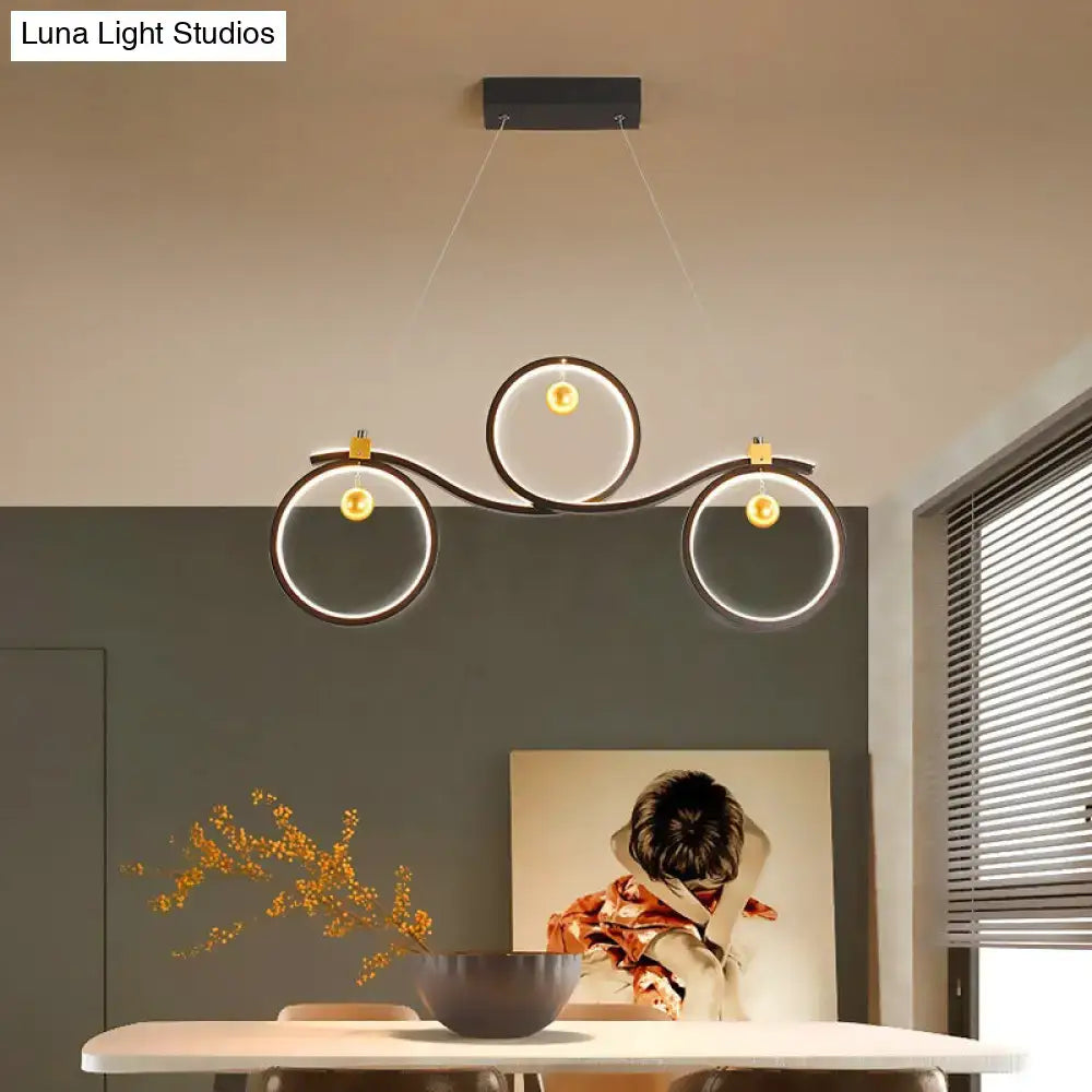 Contemporary black metal led pendant light with symmetrical rings and glowing gold bulbs for rings island lighting