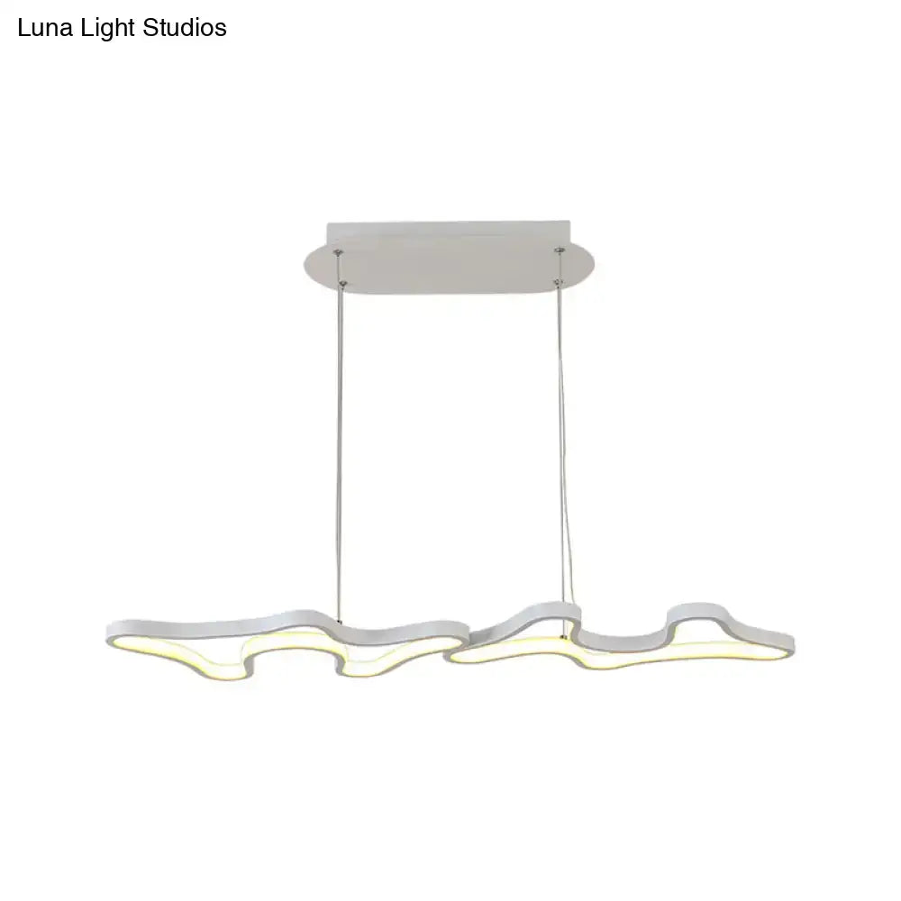 Modern white led island light with sleek wave design and chrome metal suspension cords in black white DecorBites™ style