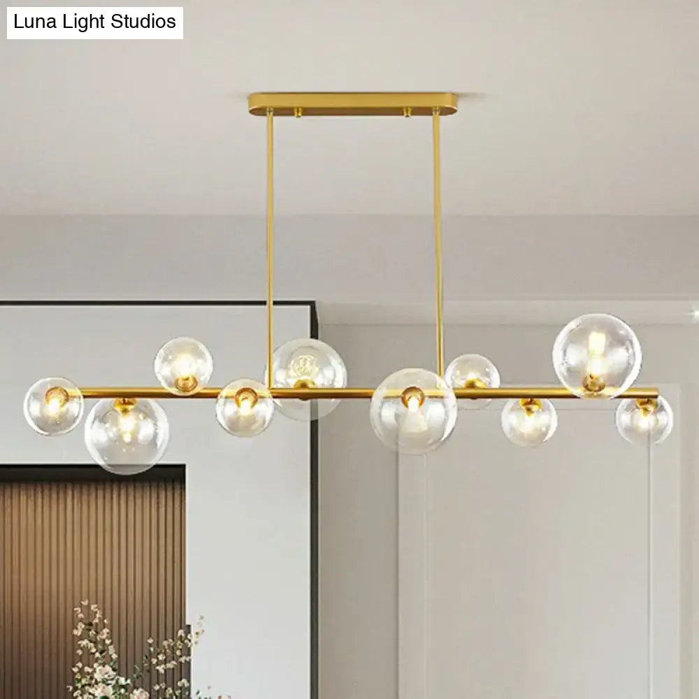 DecorBites™ contemporary gold-toned ceiling light with clear glass globe bulbs and sleek horizontal bar for dining room