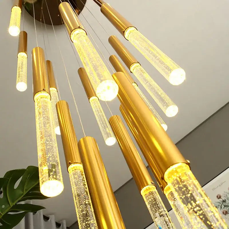 Golden cylindrical pendant lights with clear glass tubes and glowing bubbles in decorbites™ contemporary crystal chandelier for large staircase