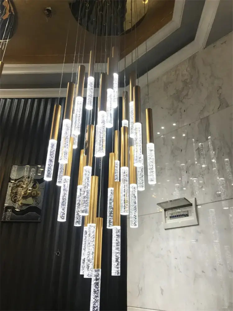 DecorBites contemporary crystal chandelier with gold-toned rods and bubble-filled crystals for large staircase lighting