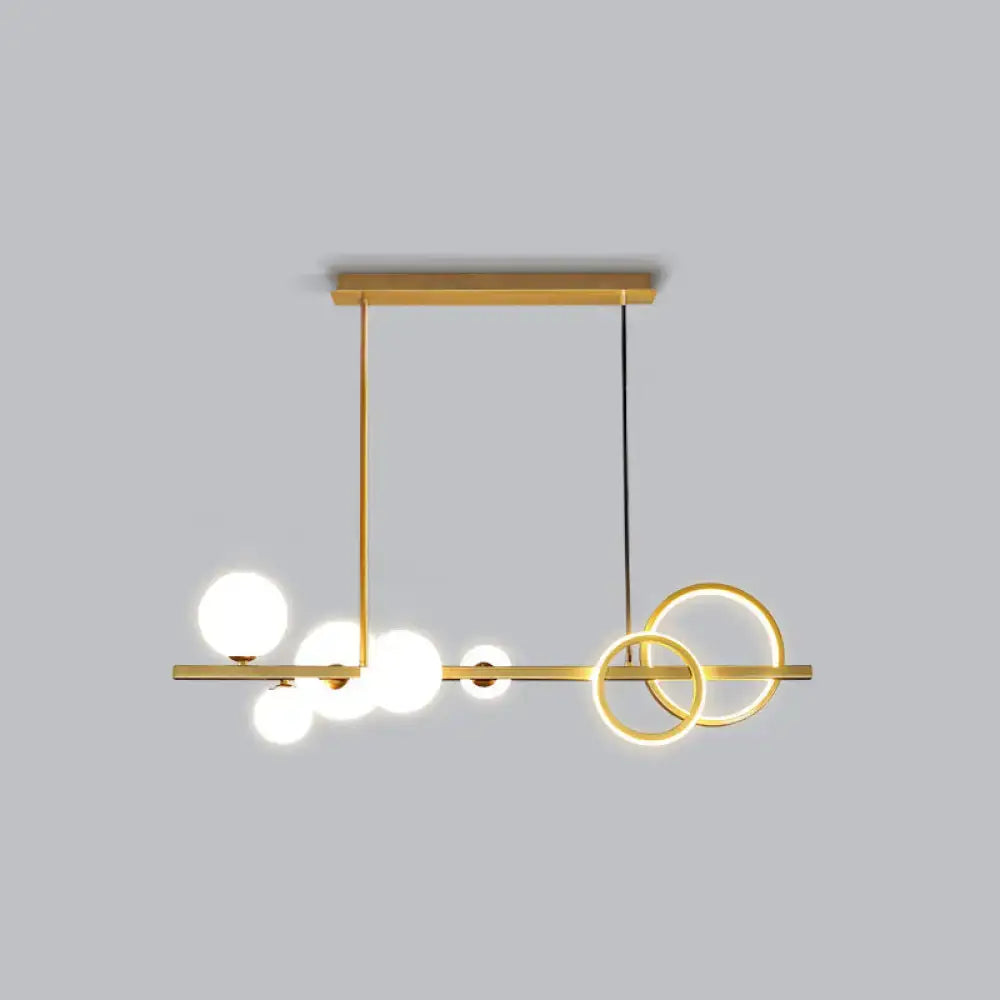 Decorbites contemporary glass island lamp with gold-toned pendant, milk white spherical bulbs, and smoke grey rings