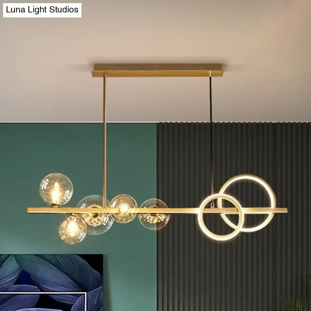 DecorBites™ contemporary gold-toned island lamp with clear glass globes and interlocking rings for dining room lighting