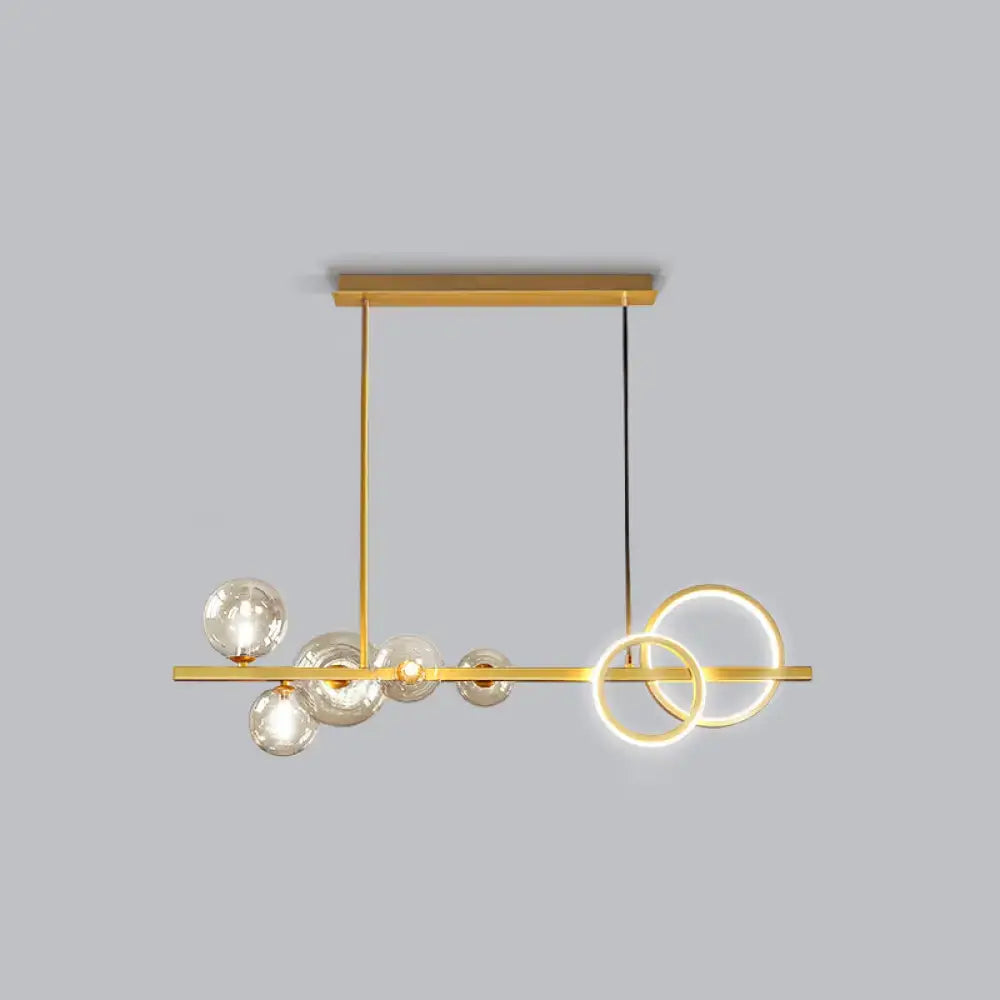 Decorbites contemporary 7-head island lamp with gold-toned bar, milk white glass spheres, and smoke grey circular rings