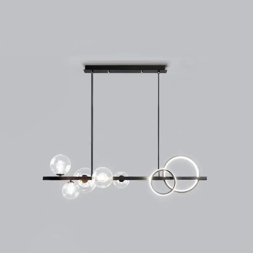 Modern black metal decorbites island lamp with clear glass globe bulbs and glowing smoke grey led rings for dining room