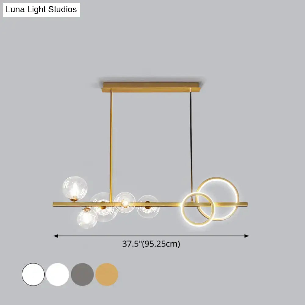 DecorBites contemporary 7-head island lamp with gold-toned frame clear glass spheres and glowing circular rings for dining room