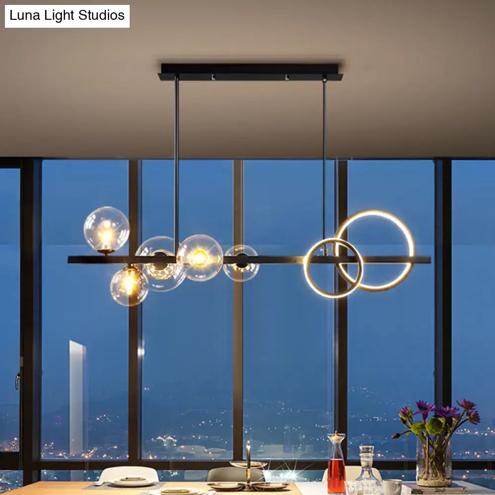 DecorBites™ contemporary 7-head island lamp with clear glass spheres, glowing gold rings, black frame, perfect for dining room