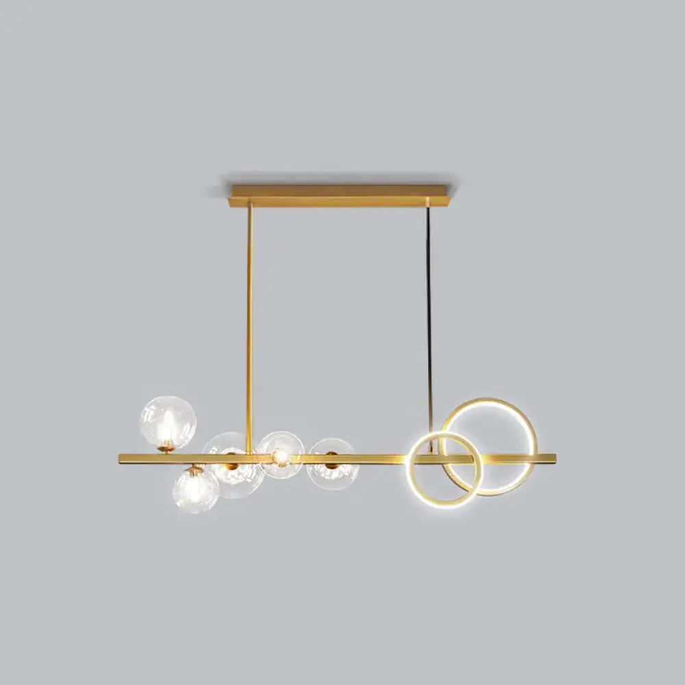 Decorbites contemporary 7-head island lamp with gold-toned frame, clear glass globes, glowing circular rings in milk white and smoke grey