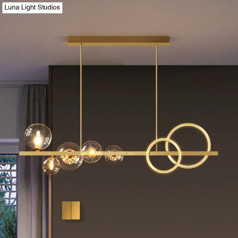 DecorBites contemporary 7-head gold-toned island lamp with smoke grey glass globes and intersecting circular rings