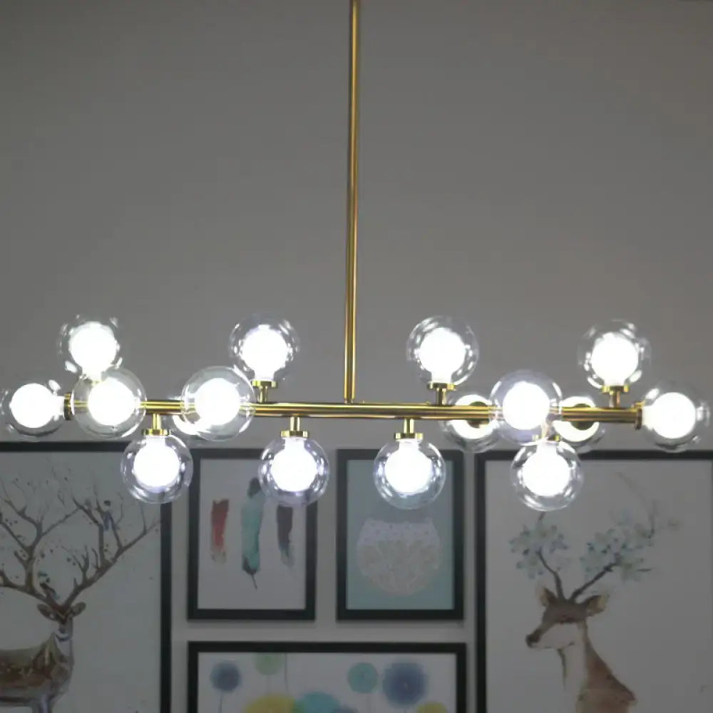 DecorBites™ contemporary gold-toned chandelier with clear glass globe bulbs designed for living room island lighting