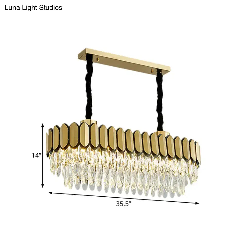 Gold-toned decorbites™ oval island light with clear crystal droplets and LED bulbs on sleek metal frame