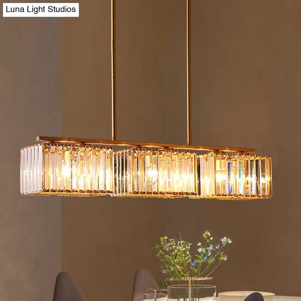 Gold-toned DecorBites contemporary pendant lighting with clear cuboid crystal shade and warm glowing led incandescent lights