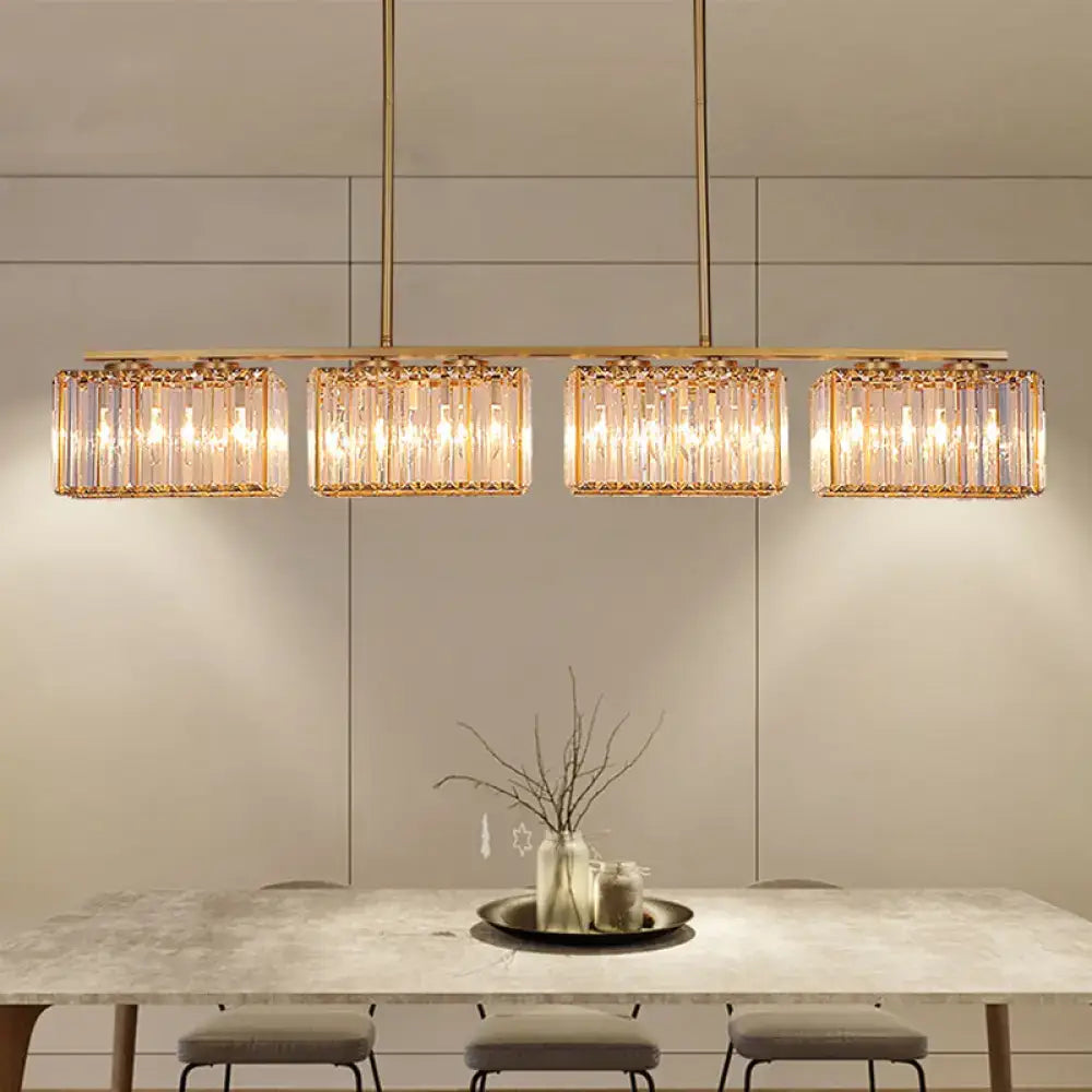 Contemporary gold pendant lighting with clear cuboid crystal shade and warm led incandescent fluorescent glow for dining room