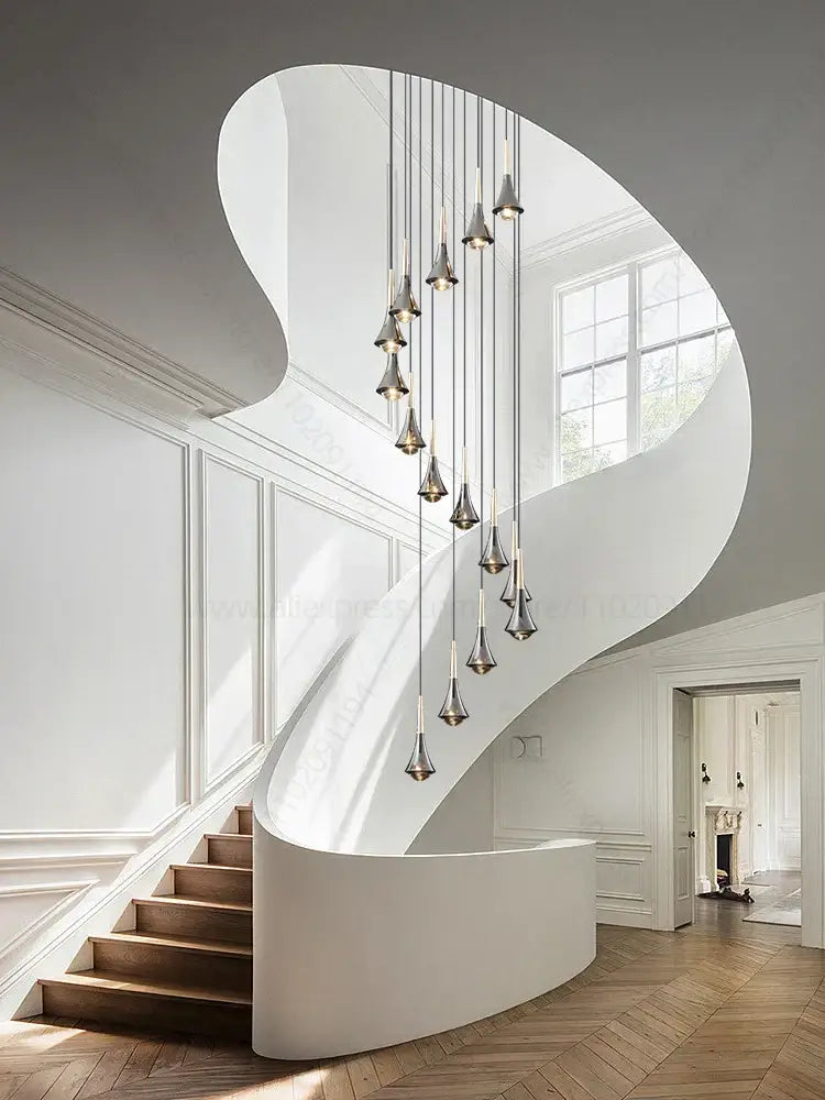 A modern curved staircase with sleek white finish and wooden steps featured with decorbites contemporary horn chandelier