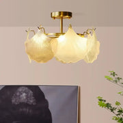Gold-toned decorbites contemporary led chandelier with three translucent leaf-shaped glass shades for dining room lighting
