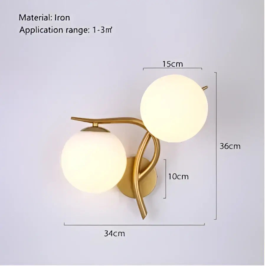 Gold-toned iron wall sconce with two frosted glass globes for contemporary led glass home lighting by DecorBites