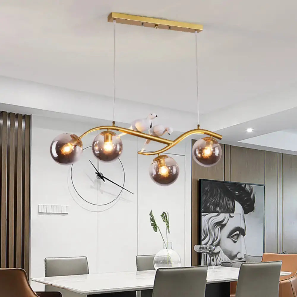 Decorbites contemporary metal branch pendant lamp with gold curved arm and smoke grey cognac glass shades