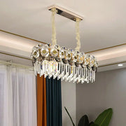 Elegant oval-shaped DecorBites™ metal facing island chandelier with polished chrome frame and clear crystal prisms