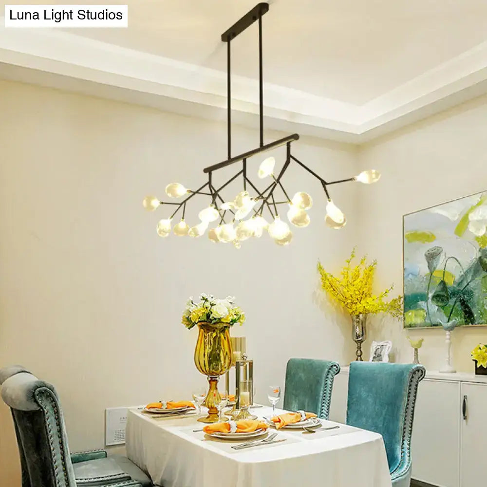 Modern black metal pendant chandelier with branching arms frosted glass globe lights and round canopy for bedroom lighting