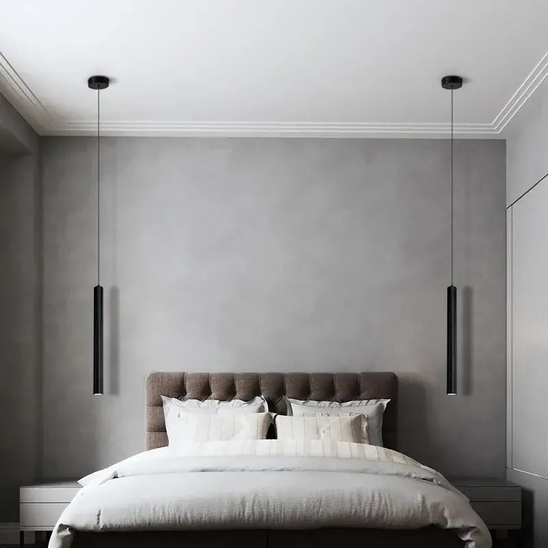 Two sleek black DecorBites™ contemporary nordic led pendant lights hang symmetrically above a bed